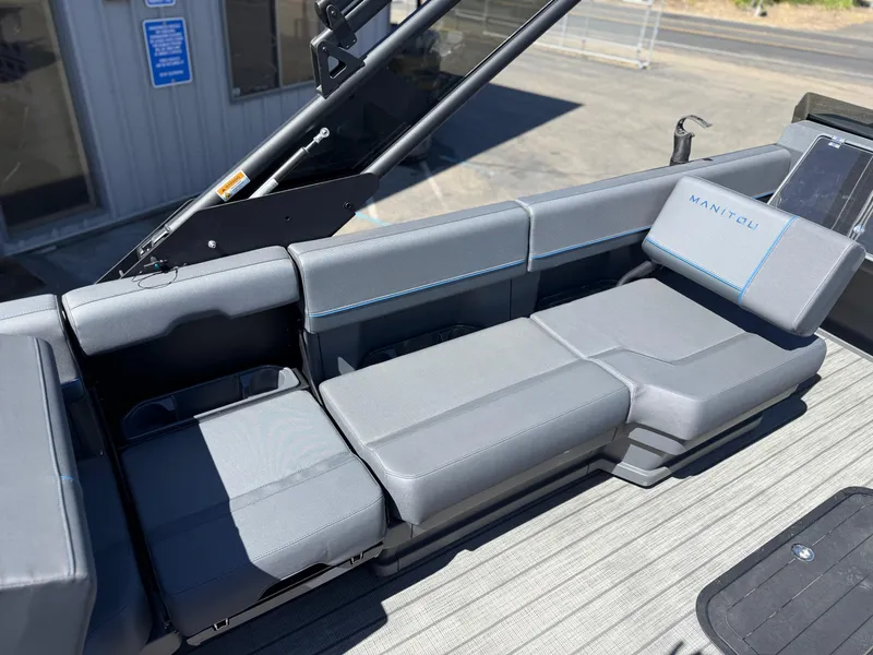 Slide: The Image of Luxurious seating on 2025 Manitou Explore Dual Engine boat, featuring sleek gray upholstery. - 14