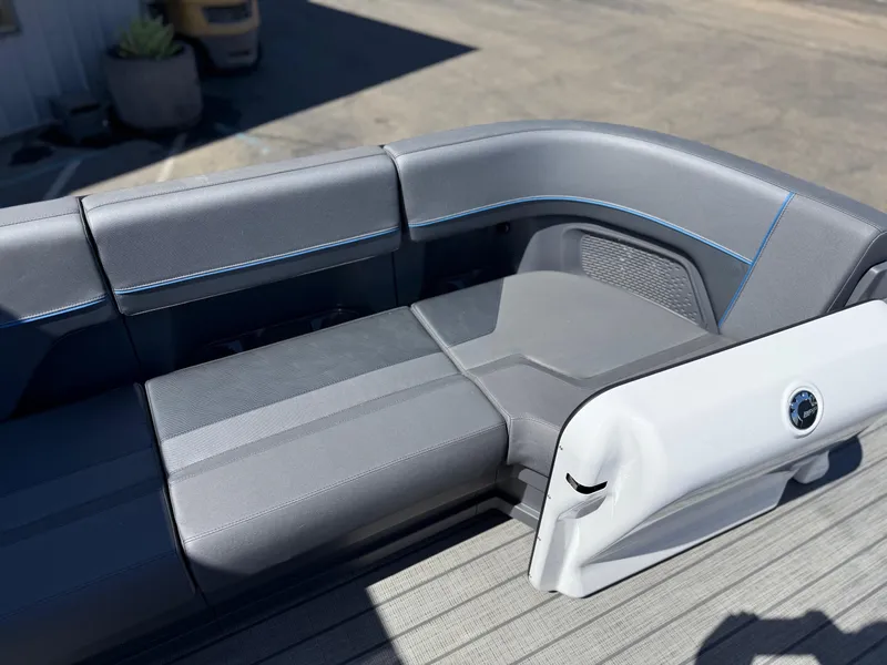 Slide: The Image of 2025 Manitou Explore Dual Engine boat interior with sleek gray seating and modern design. - 19