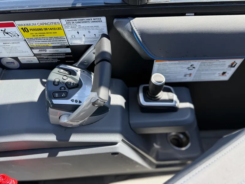 Slide: The Image of Control panel of 2025 Manitou Explore Dual Engine boat with capacity and compliance labels. - 9