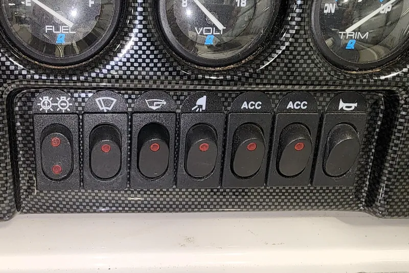 Slide: The Image of Dashboard switches of a 1999 Campion Explorer 552 boat with fuel and volt gauges. - 10