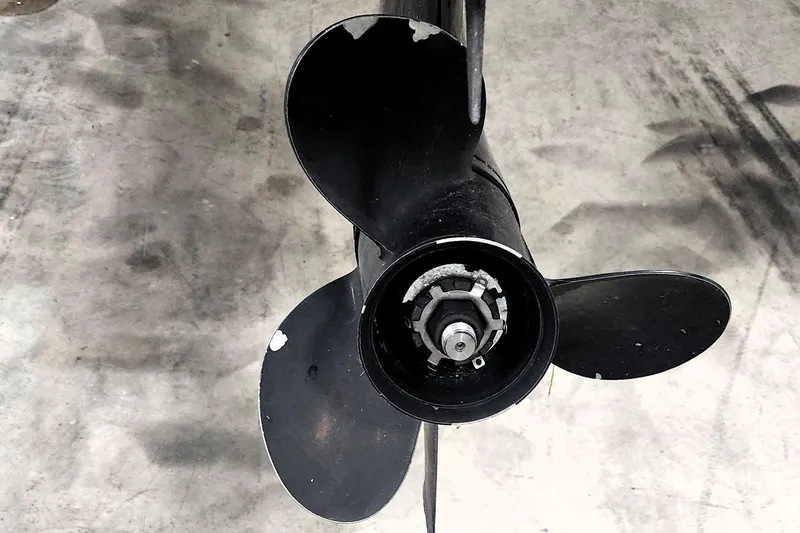 Slide: The Image of Black boat propeller of a 1999 Campion Explorer 552 on concrete floor. - 11