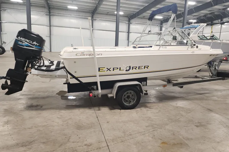 Slide: The Image of 1999 Campion Explorer 552 boat on trailer in indoor storage facility. - 12