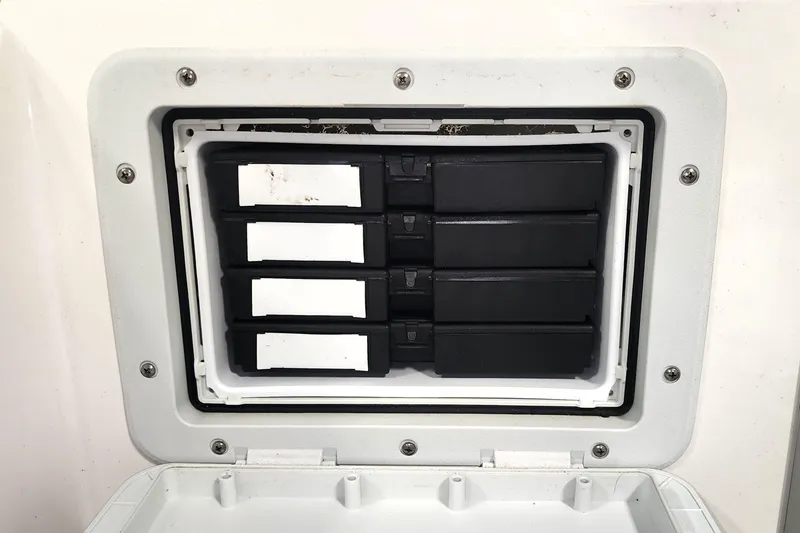 Slide: The Image of Storage compartment with black boxes in a 1999 Campion Explorer 552 boat. - 15