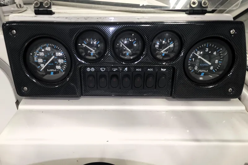 Slide: The Image of Dashboard of a 1999 Campion Explorer 552 boat with gauges and switches. - 7
