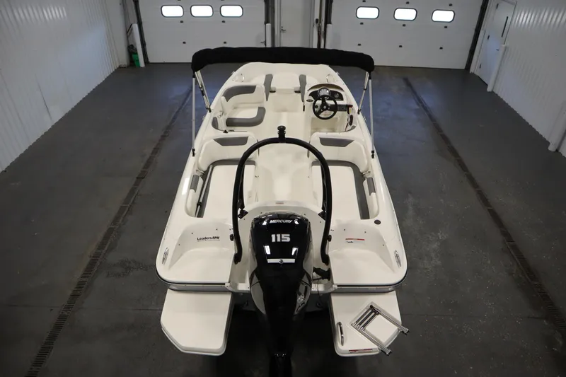 Slide: The Image of 2022 Bayliner E18 Element boat in a garage, featuring a Mercury 115 engine. - 10