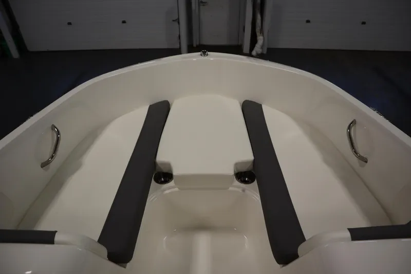 Slide: The Image of 2022 Bayliner E18 Element boat interior with gray seating and stainless steel handles. - 11