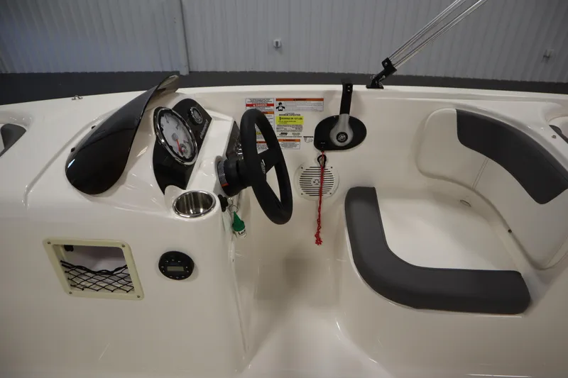Slide: The Image of 2022 Bayliner E18 Element boat interior with steering wheel and seating. - 16