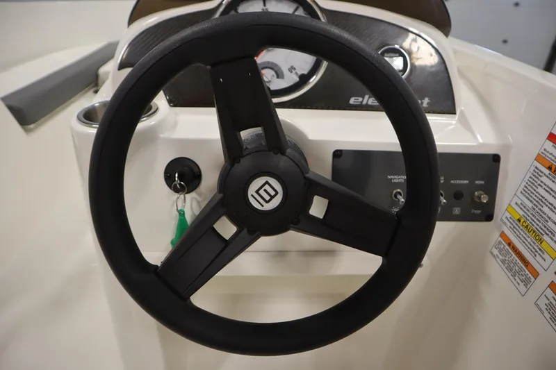 Slide: The Image of 2022 Bayliner E18 Element steering wheel and dashboard controls. - 19