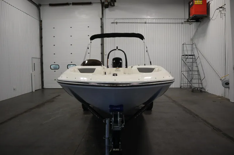 Slide: The Image of 2022 Bayliner E18 Element boat in a garage, front view. - 2