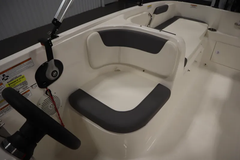 Slide: The Image of 2022 Bayliner E18 Element boat interior with seating and steering wheel. - 23