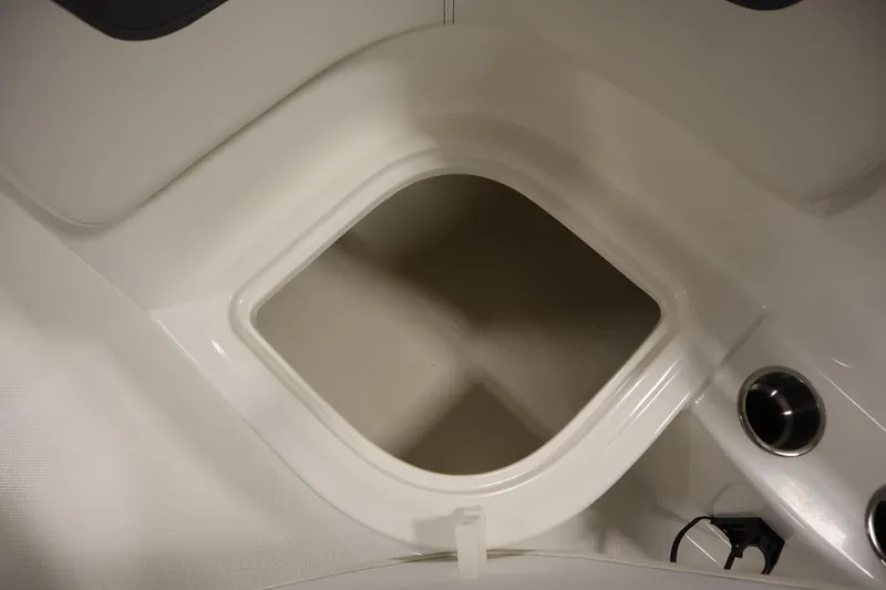 Slide: The Image of 2022 Bayliner E18 Element boat interior storage compartment with cup holders. - 27