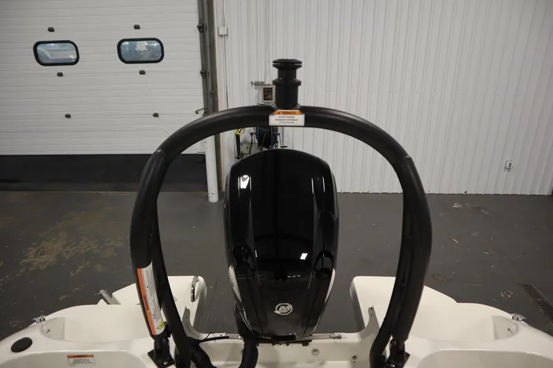 Slide: The Image of 2022 Bayliner E18 Element boat engine and arch in a garage setting. - 32