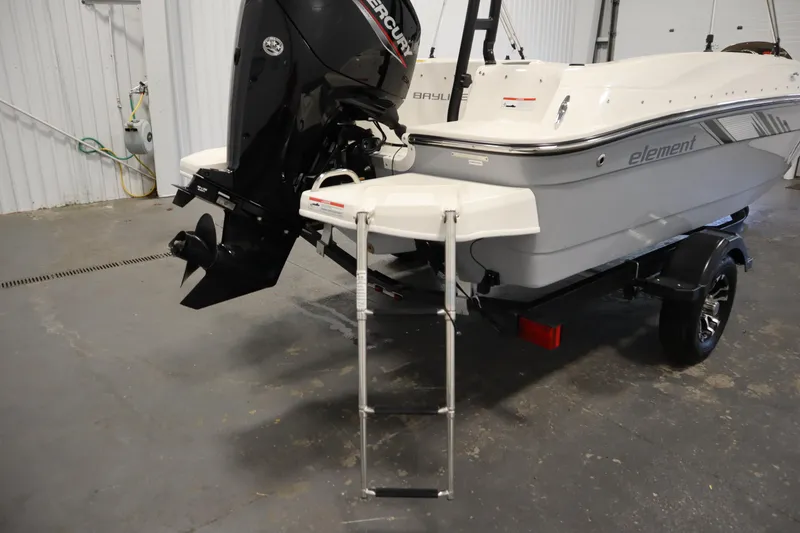 Slide: The Image of 2022 Bayliner E18 Element boat with outboard motor and ladder in a garage. - 33