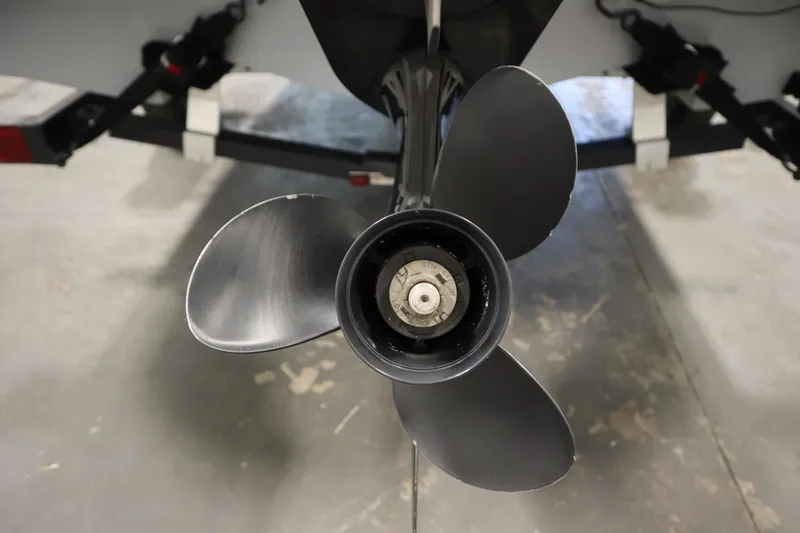 Slide: The Image of Close-up of a 2022 Bayliner E18 Element boat propeller in a garage setting. - 37