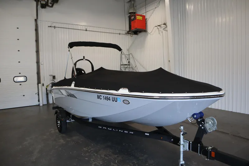 Slide: The Image of 2022 Bayliner E18 Element boat with cover in a garage setting. - 41