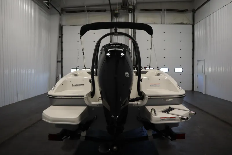 Slide: The Image of 2022 Bayliner E18 Element boat in a garage, rear view with motor. - 6