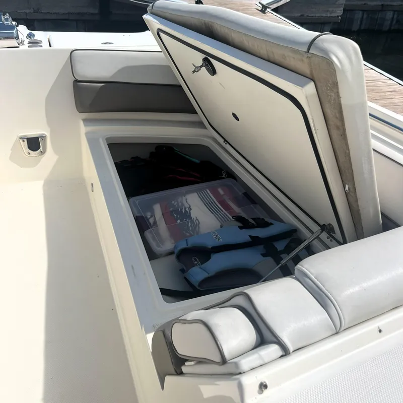 Slide: The Image of 2016 World Cat 320 DC boat storage compartment with life jacket and gear. - 12