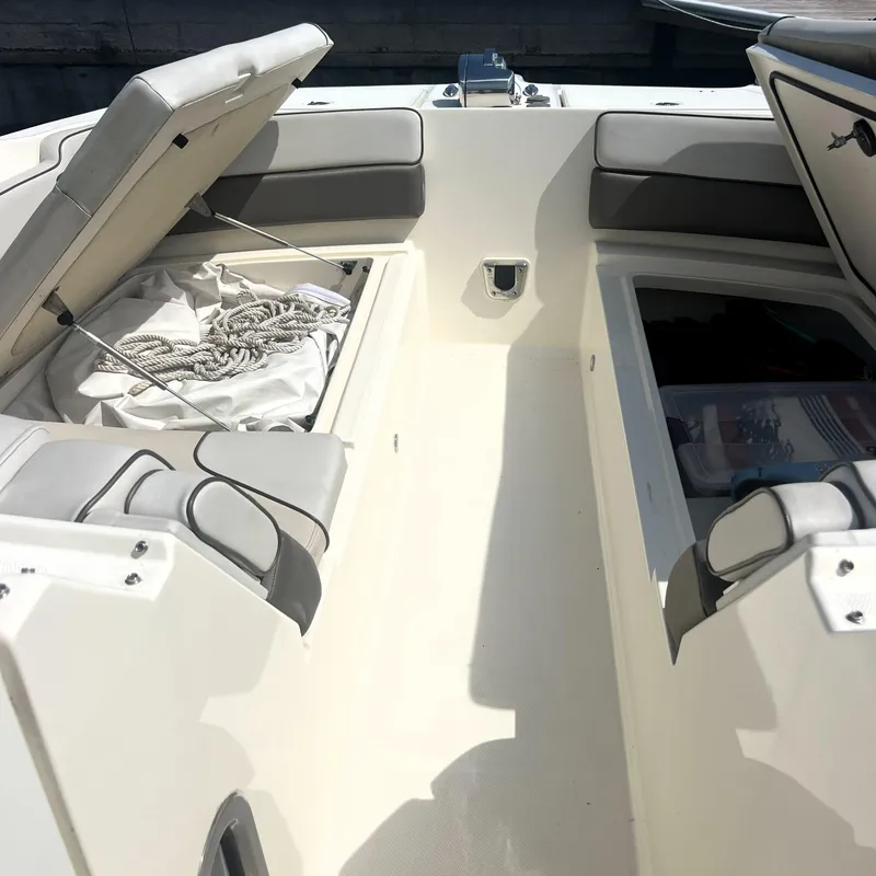 Slide: The Image of 2016 World Cat 320 DC boat interior with open storage compartments and seating. - 13