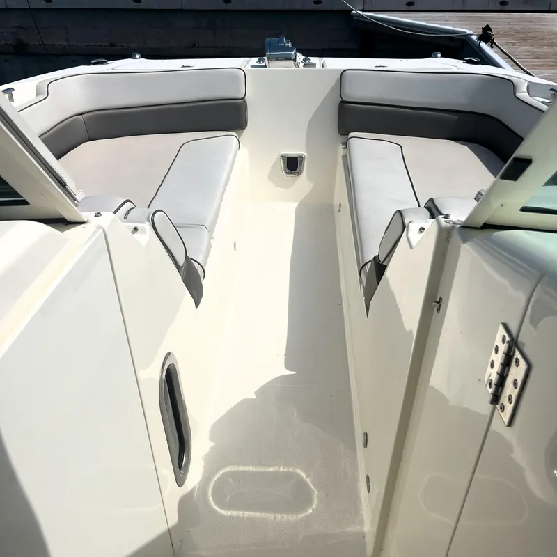 Slide: The Image of 2016 World Cat 320 DC boat interior with cushioned seating and sleek design. - 14