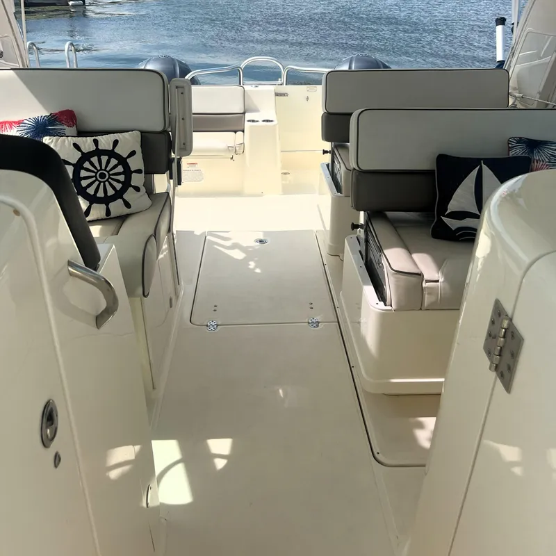 Slide: The Image of Interior of 2016 World Cat 320 DC boat with cushioned seating and nautical-themed pillows. - 15