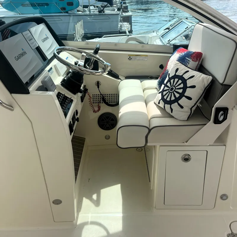 Slide: The Image of 2016 World Cat 320 DC helm with Garmin displays and nautical-themed cushion. - 16