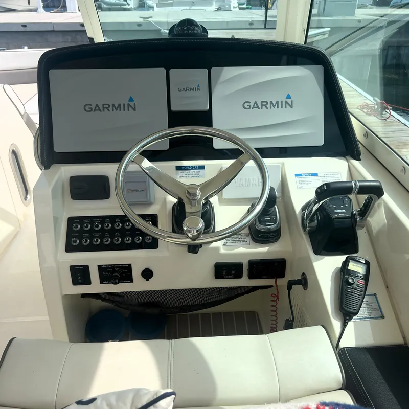 Slide: The Image of Helm of 2016 World Cat 320 DC with Garmin navigation displays and controls. - 17
