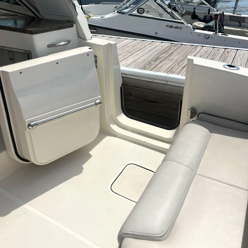 Slide: The Image of 2016 World Cat 320 DC boat interior with seating and open door, docked at marina. - 18