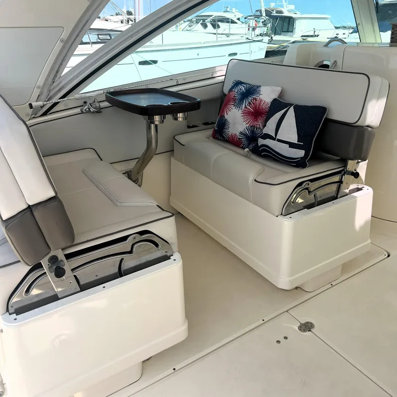 Slide: The Image of Interior of 2016 World Cat 320 DC boat with cushioned seating and nautical-themed pillows. - 23