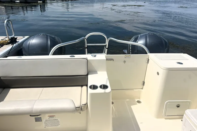 Slide: The Image of 2016 World Cat 320 DC boat interior with seating and twin outboard engines. - 24