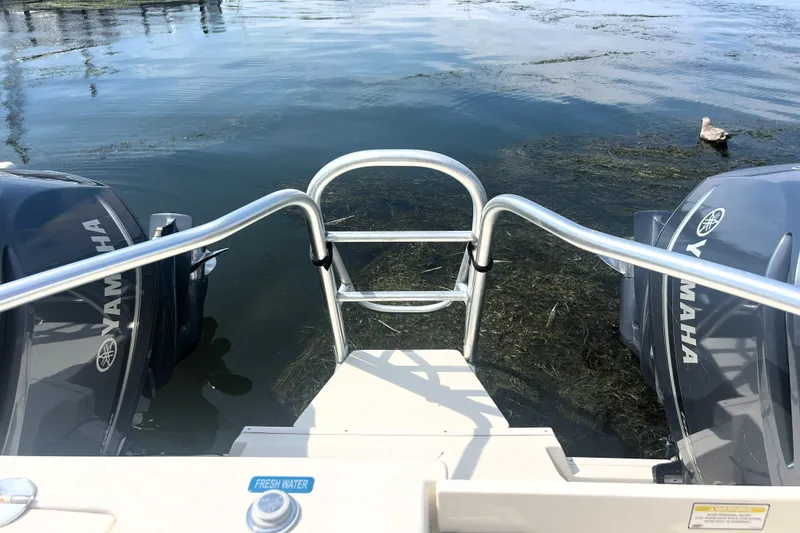 Slide: The Image of 2016 World Cat 320 DC boat with Yamaha engines, rear view over water. - 25