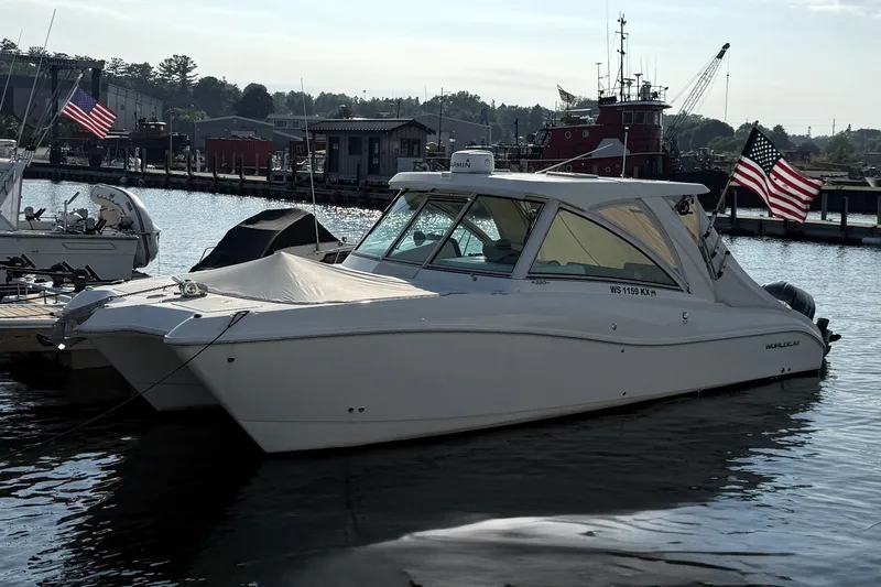 Slide: The Image of 2016 World Cat 320 DC boat docked in a marina with American flags. - 30