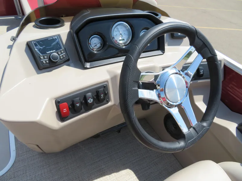 Slide: The Image of 2024 Bennington 22 SSR boat dashboard with steering wheel and control panel. - 8