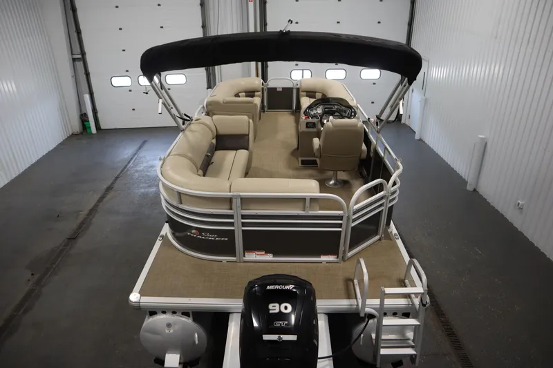 Slide: The Image of 2022 Tracker 20 Party Barge DLX pontoon boat in indoor storage. - 10