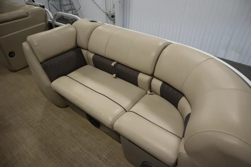 Slide: The Image of 2022 Tracker 20 Party Barge DLX boat interior with beige cushioned seating. - 12