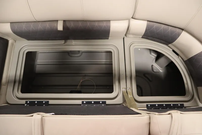 Slide: The Image of 2022 Tracker 20 Party Barge DLX storage compartments with open lids. - 14