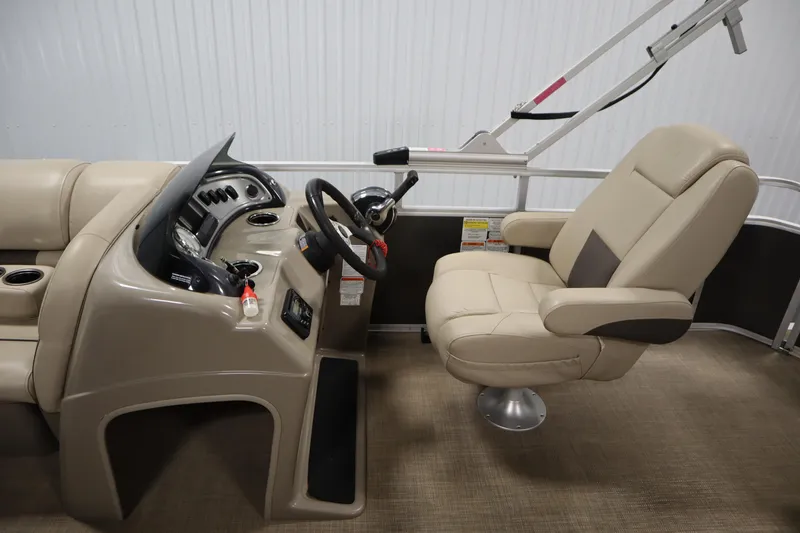 Slide: The Image of 2022 Tracker 20 Party Barge DLX interior with steering console and captain's chair. - 22