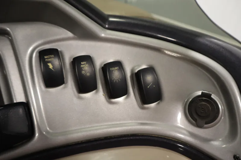 Slide: The Image of Control panel of 2022 Tracker 20 Party Barge DLX with switches and 12V outlet. - 27