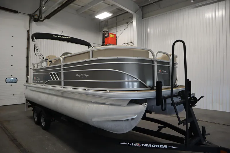 Slide: The Image of 2022 Tracker 20 Party Barge DLX pontoon boat in indoor storage. - 3