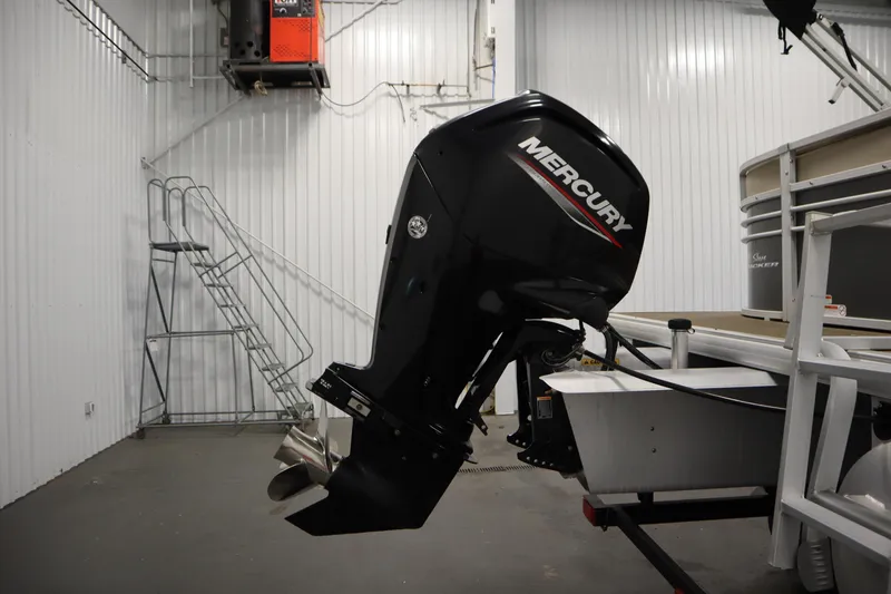 Slide: The Image of 2022 Tracker 20 Party Barge DLX with Mercury outboard motor in a garage. - 46