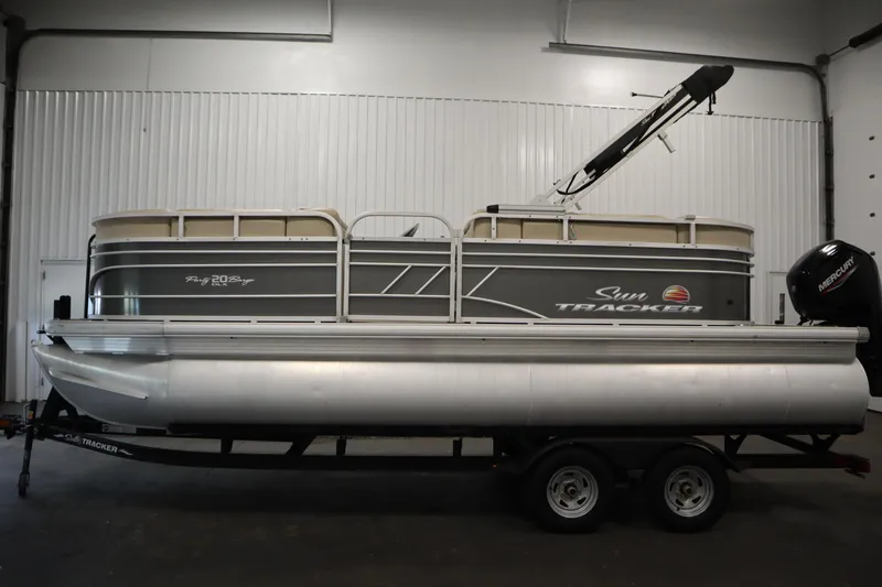 Slide: The Image of 2022 Tracker 20 Party Barge DLX pontoon boat in indoor storage. - 8