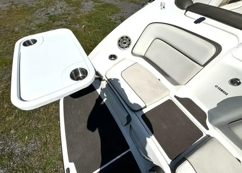 Slide: The Image of 2013 Yamaha Boats 242 Limited S interior with seating and table setup. - 12