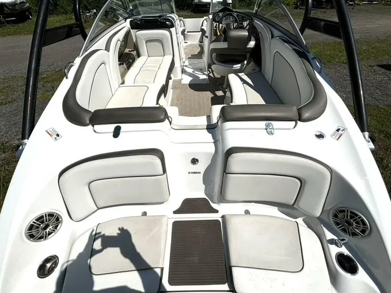 Slide: The Image of 2013 Yamaha Boats 242 Limited S interior with spacious seating and modern dashboard. - 13