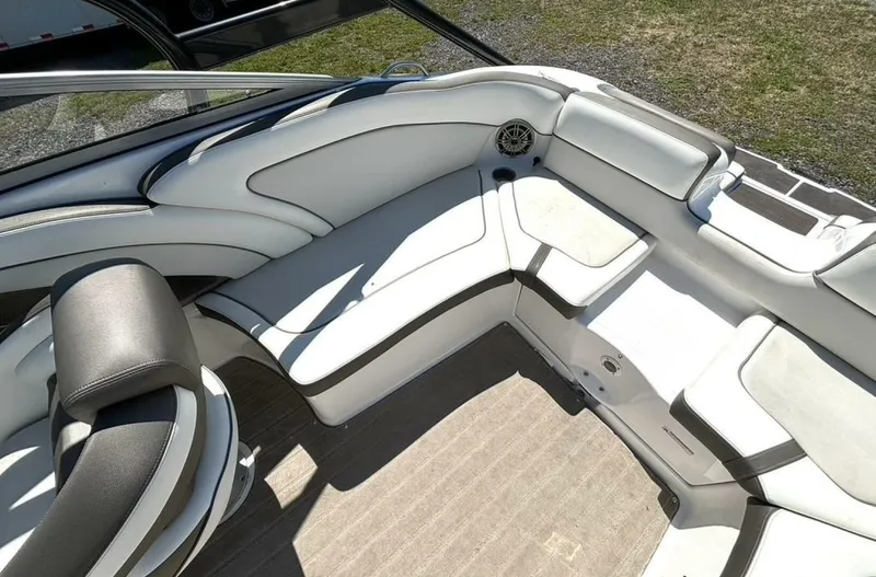 Slide: The Image of 2013 Yamaha Boats 242 Limited S interior with white seating and speaker. - 15