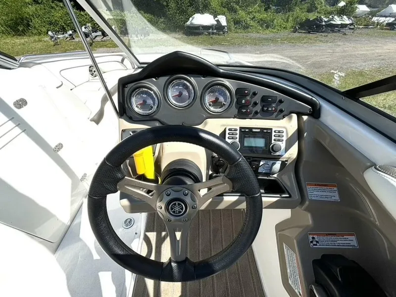 Slide: The Image of 2013 Yamaha Boats 242 Limited S dashboard with steering wheel and control panel. - 20