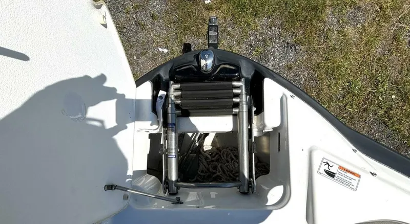 Slide: The Image of 2013 Yamaha Boats 242 Limited S bow ladder and storage compartment. - 27