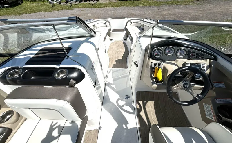 Slide: The Image of Interior view of 2013 Yamaha Boats 242 Limited S, featuring steering wheel and dashboard controls. - 24