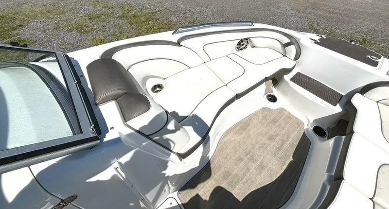 Slide: The Image of 2013 Yamaha Boats 242 Limited S interior with white seating and open deck layout. - 25