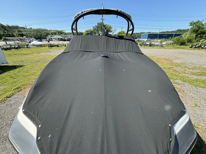 Slide: The Image of 2013 Yamaha Boats 242 Limited S covered, parked outdoors on a sunny day. - 37