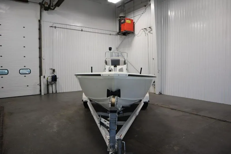 Slide: The Image of 2020 Sun Tracker Party Barge 20 DLX in a spacious indoor storage facility. - 2