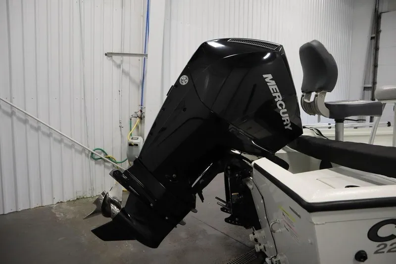 Slide: The Image of 2020 Sun Tracker Party Barge 20 DLX with Mercury outboard motor in a garage. - 43